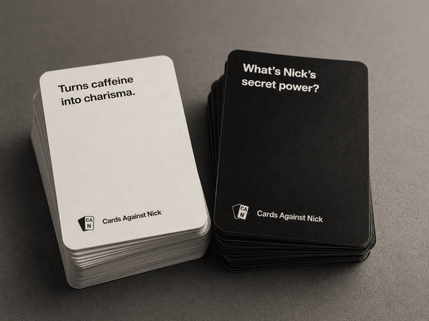 Close-up of a printed custom deck, prompt and answer card stacks