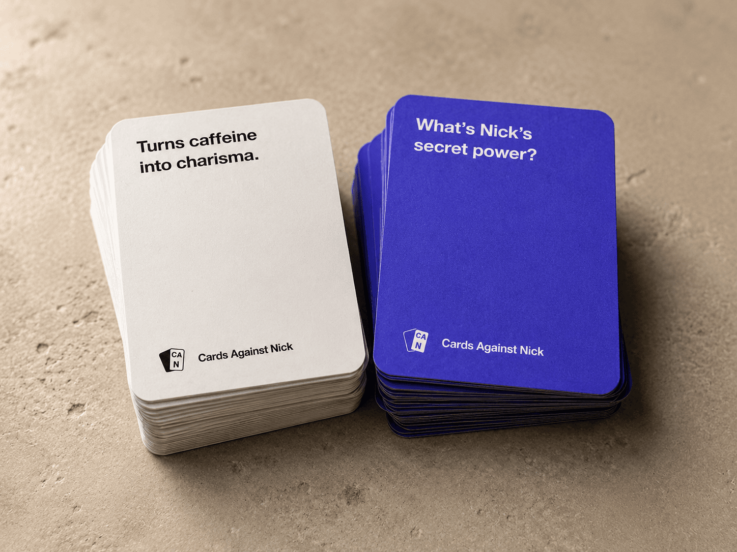 A custom card deck printed in purple, prompt and answer stacks side by side