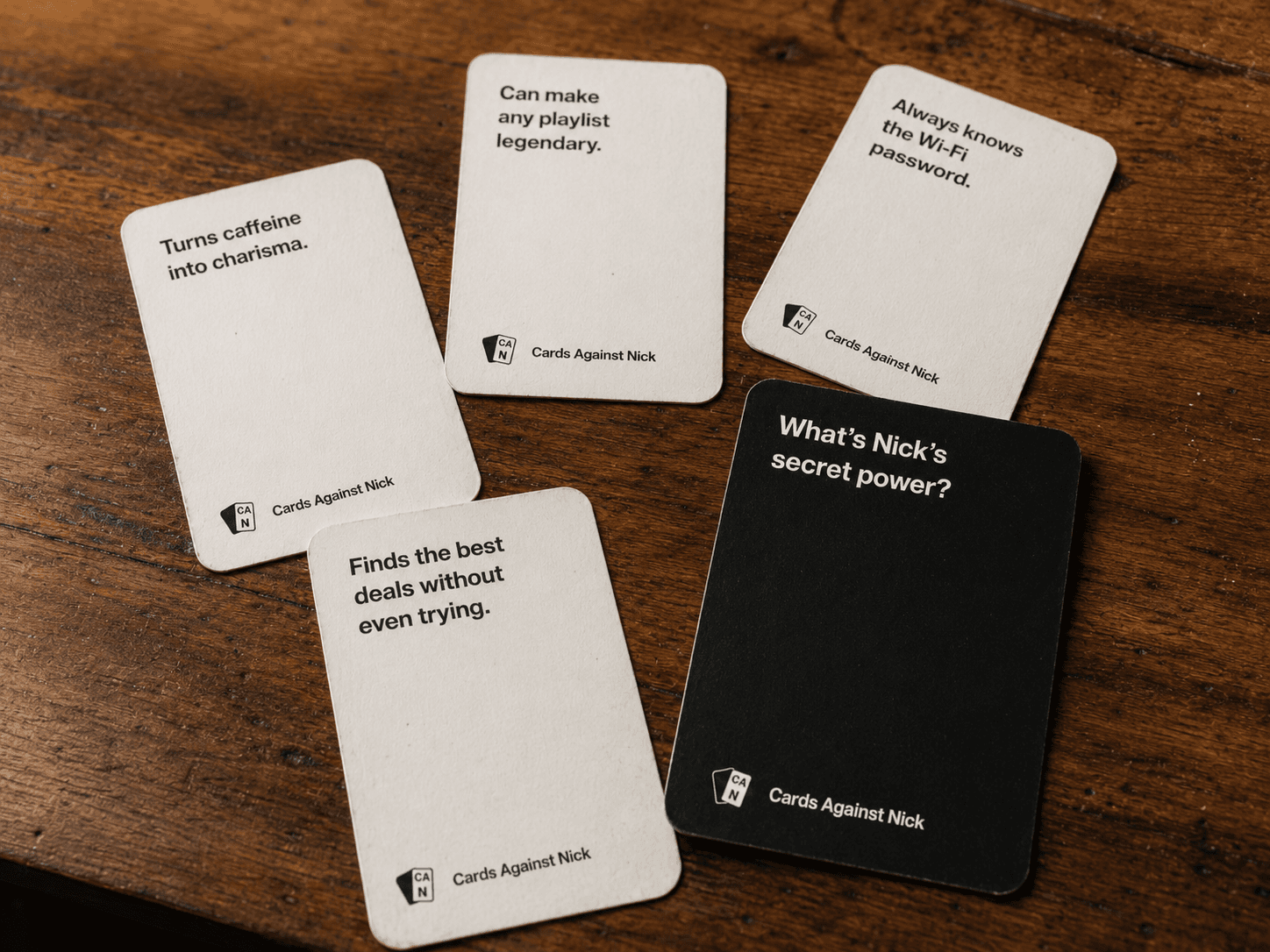 A custom printed card deck spread out on a table at game night