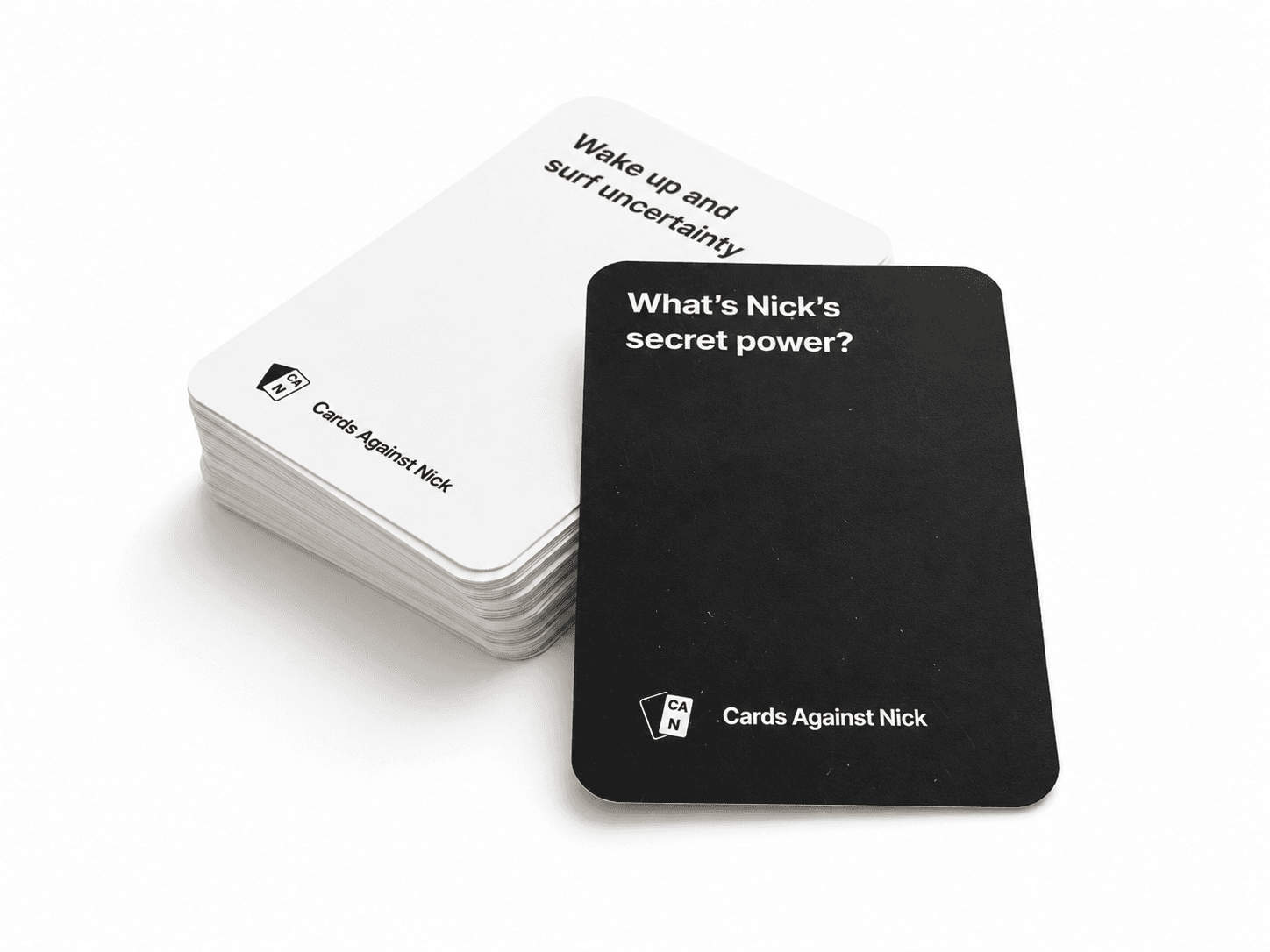 A boxed custom card deck with prompt and answer cards fanned out